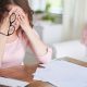 woman covering her eyes in the office