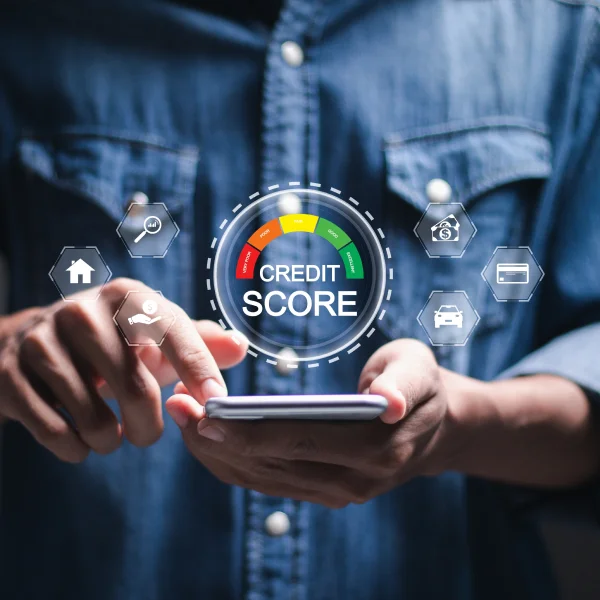 A man holds a smartphone displaying a credit score icon, symbolizing the importance of credit scores in financial health.